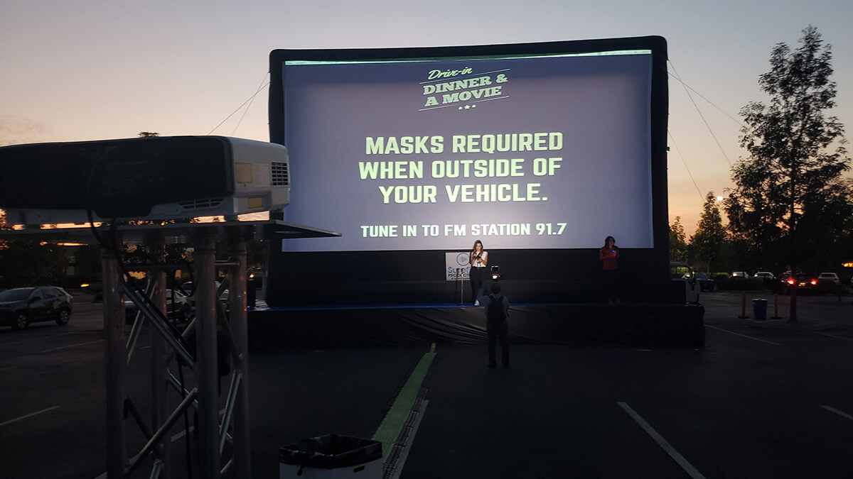 A big screen with words projected onto it.